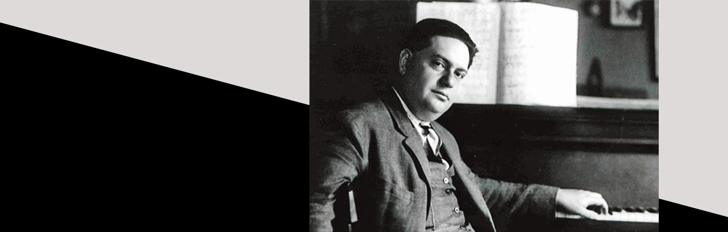 Photo of Darius Milhaud, seated at piano