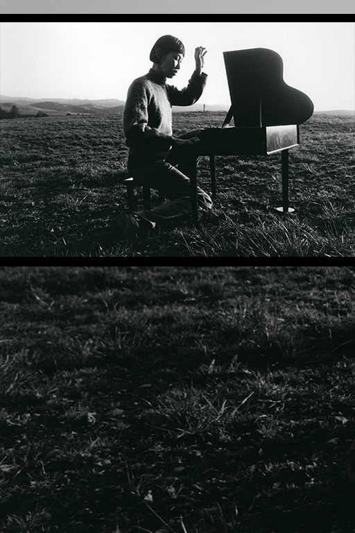Margaret Leng Tan seated at toy piano in meadow